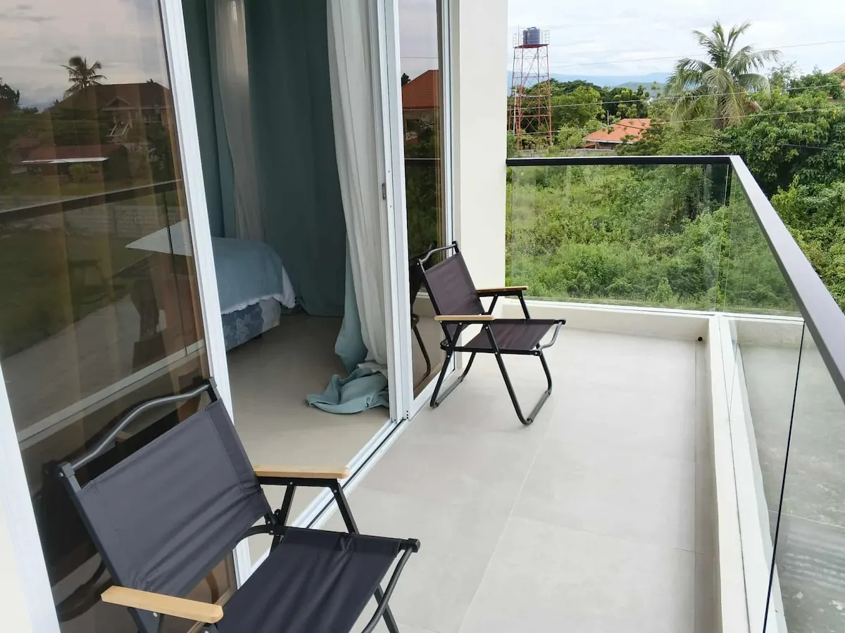Balcony with two chairs among the palms