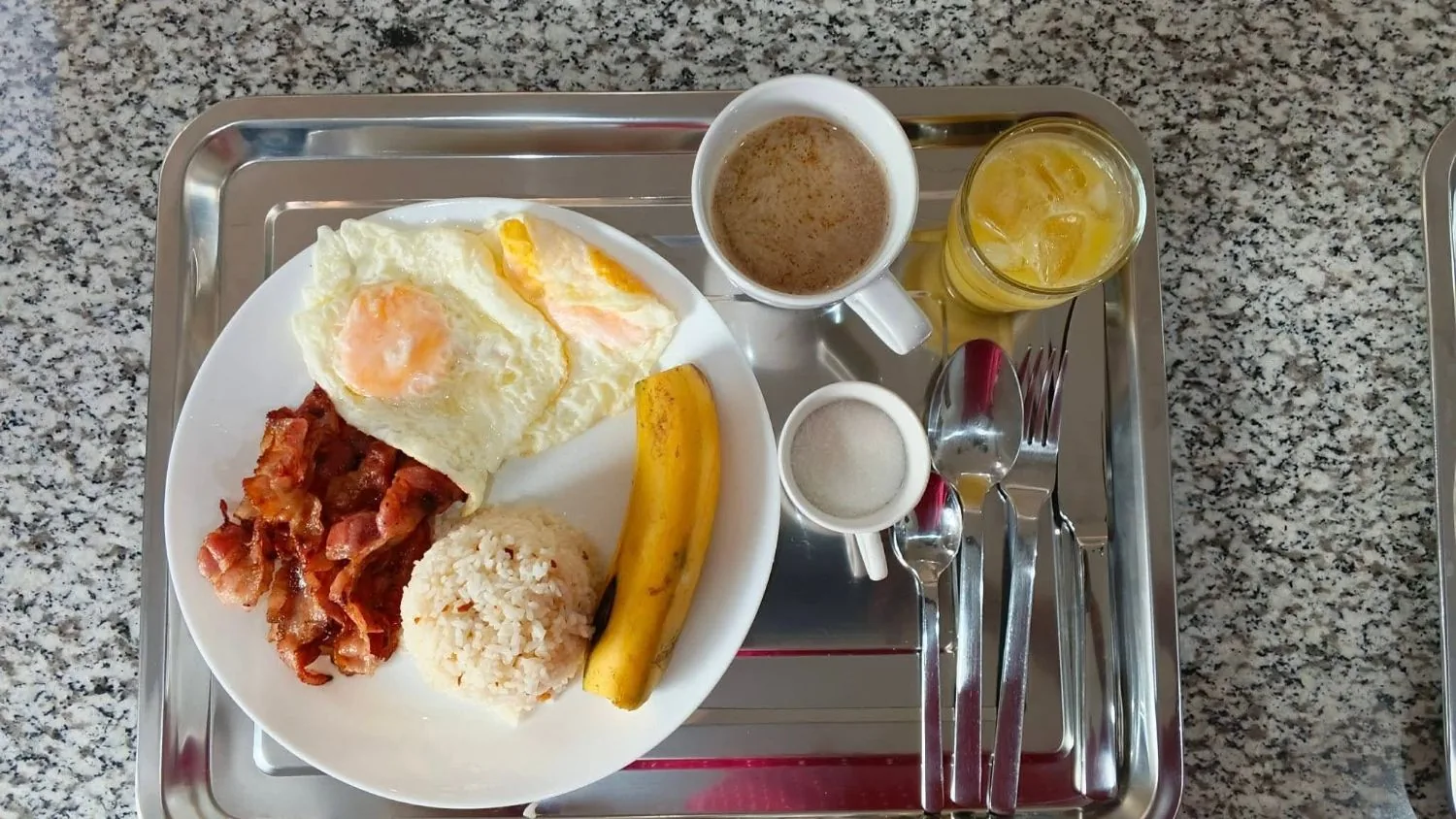 Bacsilog at OIA Suites Moalboal: crisp bacon, two fried eggs and garlic rice with a banana, coffee and orange juice