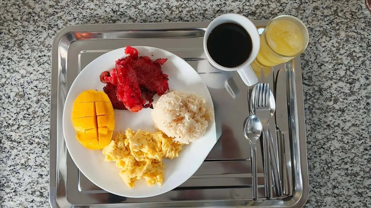 Tosilog with fresh mango at OIA Suites Moalboal: tocino, scrambled eggs, garlic rice, mango, black coffee and orange juice