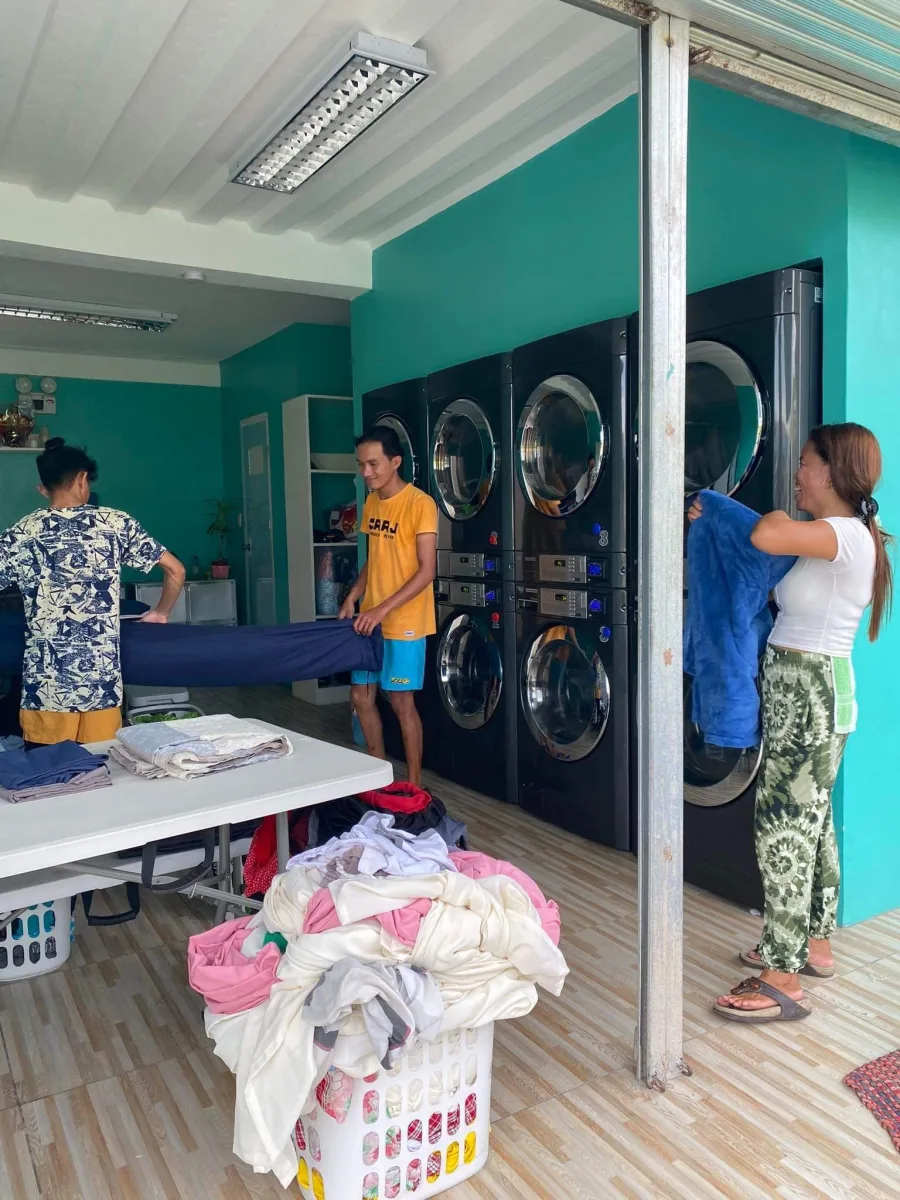 Staff folding and sorting clean laundry at Laundry Lounge Cebu
