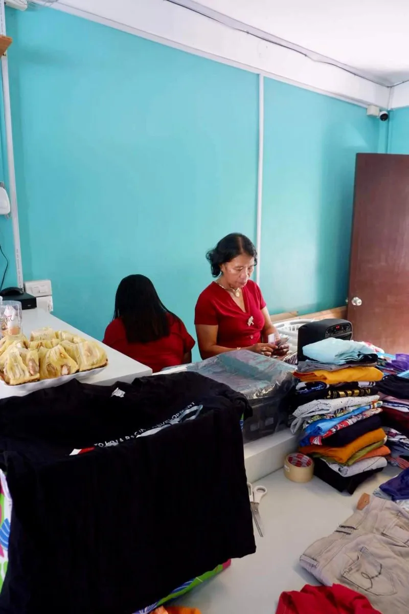 Freshly washed clothes being folded on the counter at the laundry shop in Moalboal