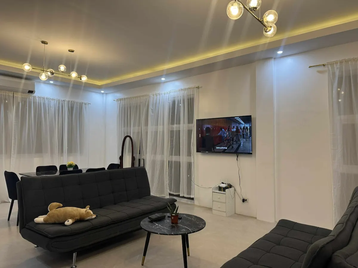 Shared living room with sofas and smart TV at OIA Suites Moalboal